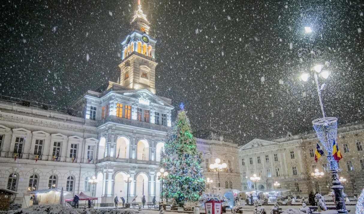 A beautiful winter scene in Arad, Romania, showcasing snowfall and festive Christmas lights.